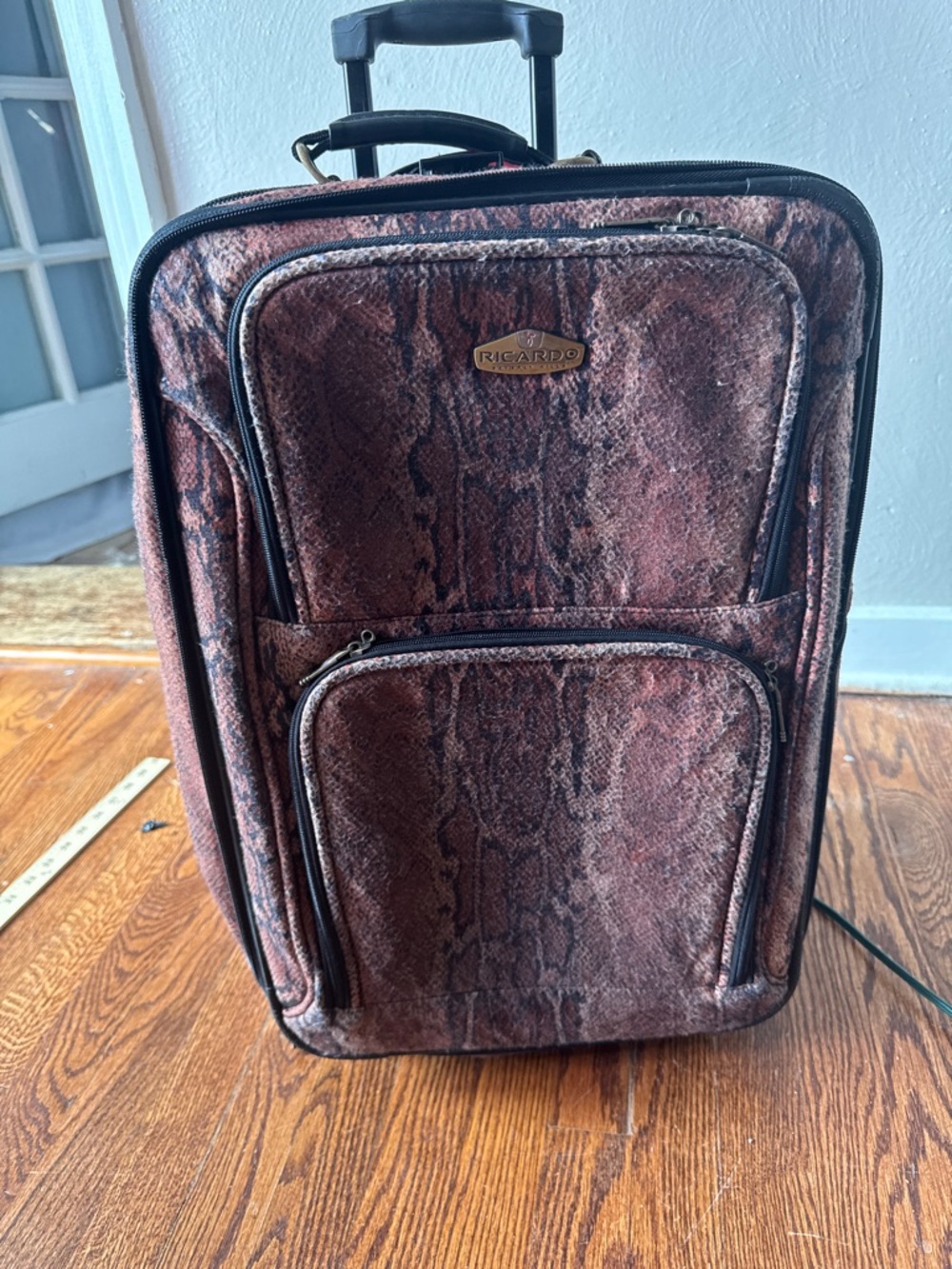 Ricardo Beverly Hills softside suitcase, reddish-reptile print.